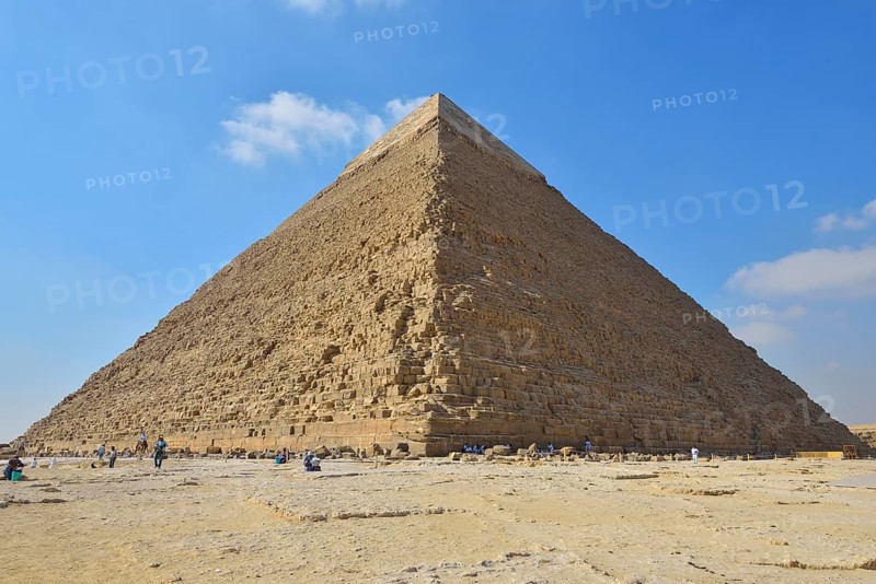 The Great Pyramid of Giza under a clear blue sky with a few scattered clouds, surrounded by tourists, Giza, Cairo, Egypt, Middle East, North Africa, Africa