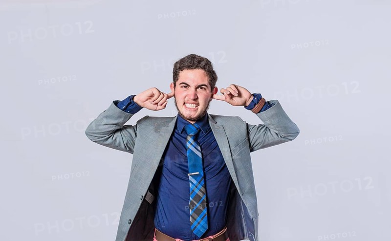 Man covering his ears isolated, guy covering his ears on isolated background, man with hands on his ears and making fun, man ignoring problems