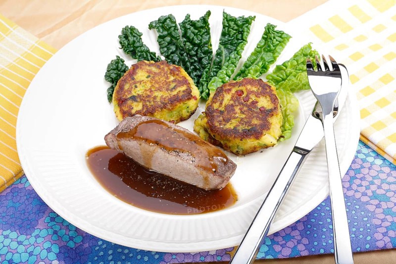 Swabian cuisine, medallions of wild boar with savoy cabbage cakes, meat dish, roasted, hearty, home cooking, typical Swabian, arranged on a plate, traditional cuisine reinterpreted, food photography, studio, Germany, Europe