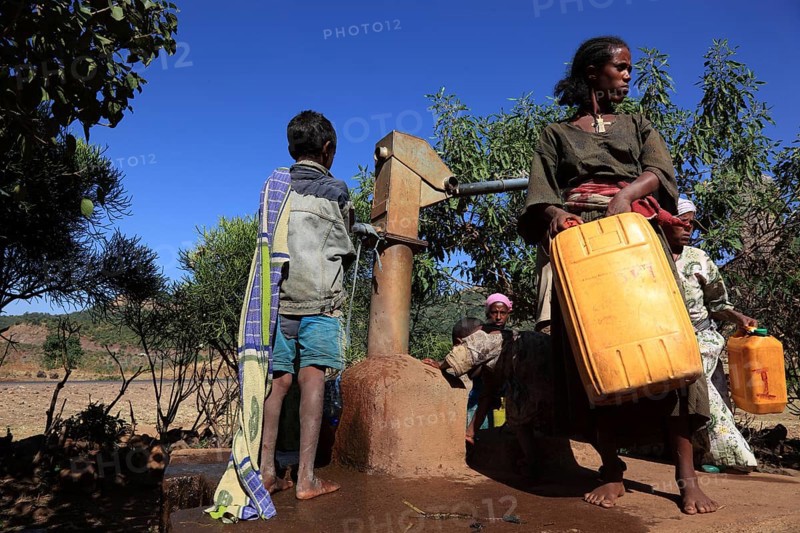 Amhara region, locals fetching water from a well, Ethiopia, Africa