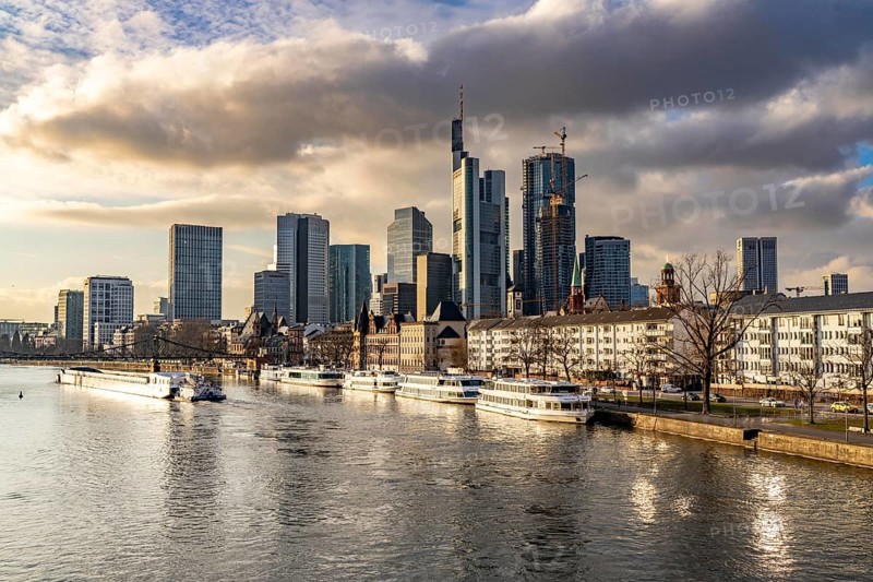 Skyline of the city centre of Frankfurt am Main, river Main, excursion boats at the Main quay, freighter, dusk, Hesse, Germany, Europe