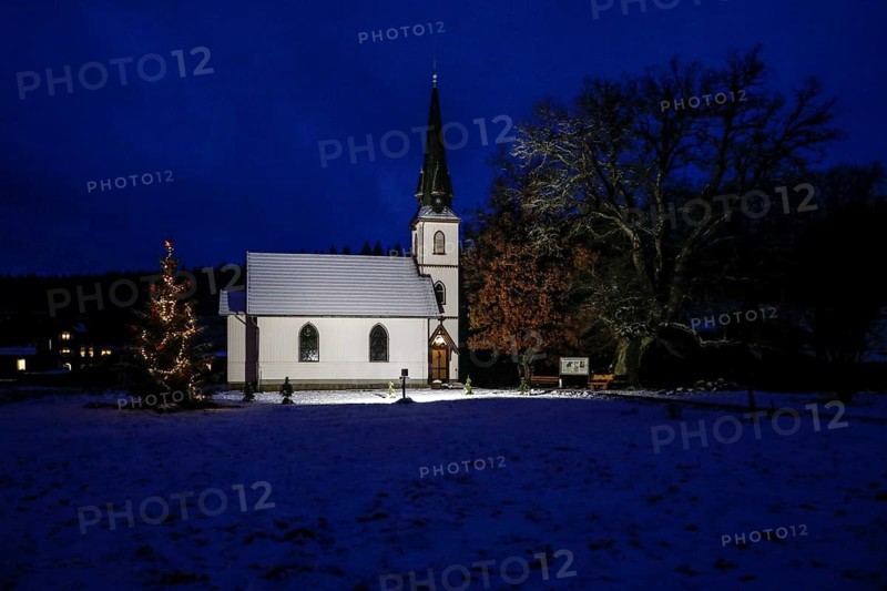 A Christmas tree stands in front of the smallest wooden church in Germany, Elend, 29 December 2020