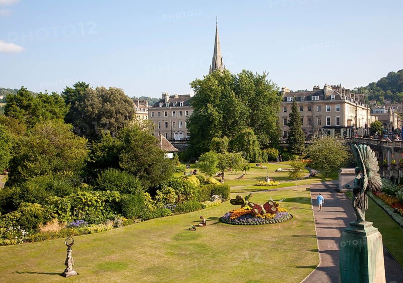 Parade Gardens public park in city centre of Bath, Somerset, England with church spire in background