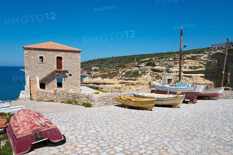 Small harbour with fishing boats and stone house on a rocky coast, Mezapos, Mani, Peloponnese, Greece, Europe