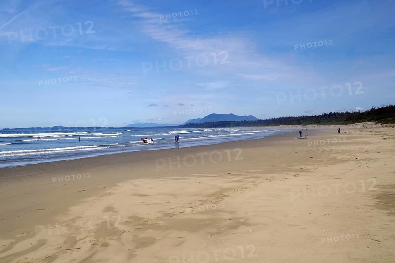 Endless empty sandy beach with swell and mountains in the background, Long Beach, Pacific Rim National Park, Vancouver Island, British Columbia