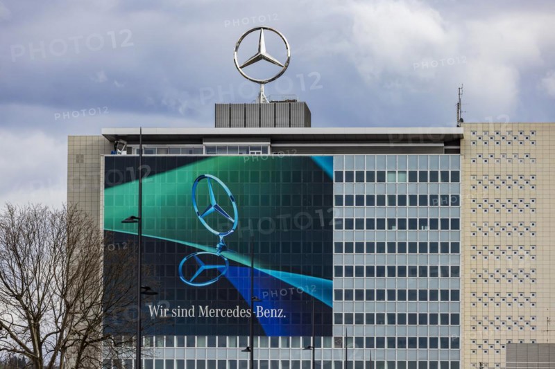 Mercedes star in front of dark clouds, office building at the headquarters of Mercedes-Benz Group AG in Untertürkheim, Stuttgart, Baden-Württemberg, Germany, Europe