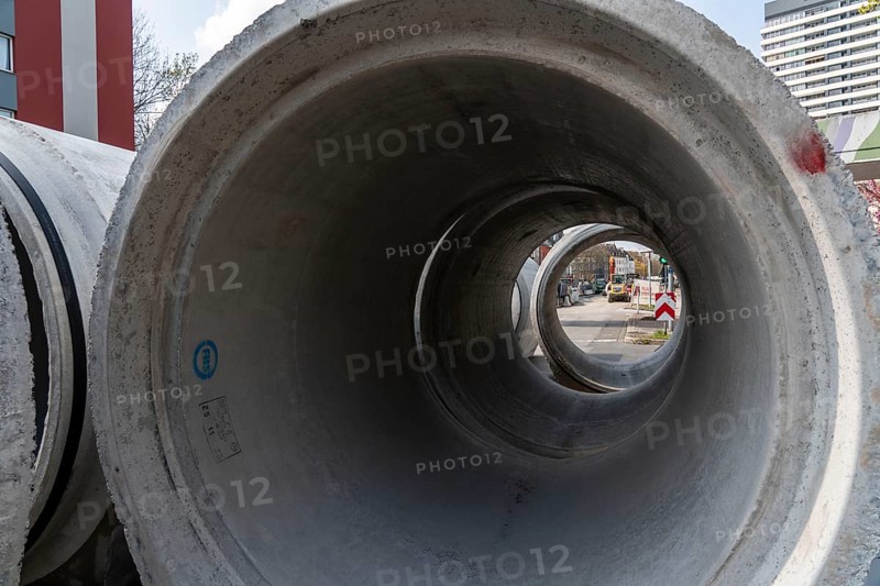 Concrete sewer pipes, stored on a construction site during sewer renovation work, on the Dickswall, city centre of Mülheim an der Ruhr, North Rhine-Westphalia, Germany, Europe