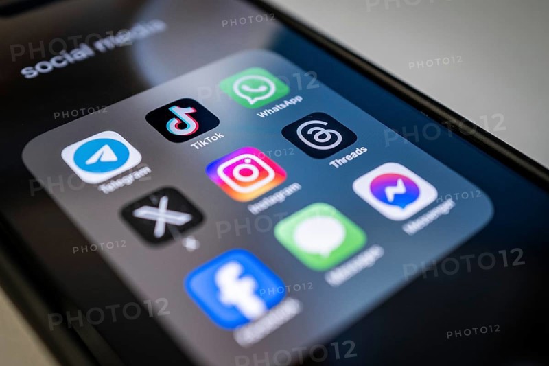 Close-up of a smartphone screen with various social media apps, diffuse light