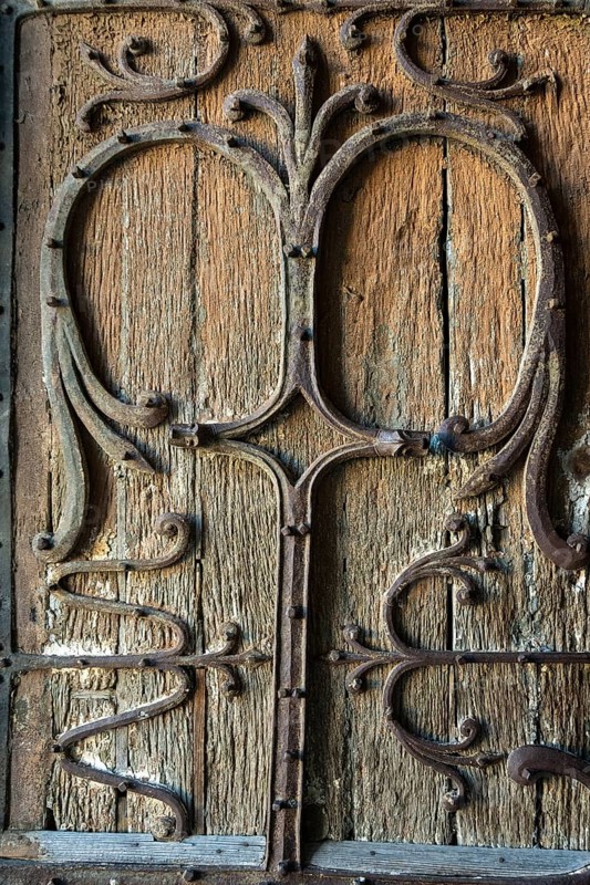 Intricate Roman wrought iron hinge displayed at the Basilica Notre-Dame d'Orcival, Puy de dome, Auvergne-Rhone-Alpes, France, Europe