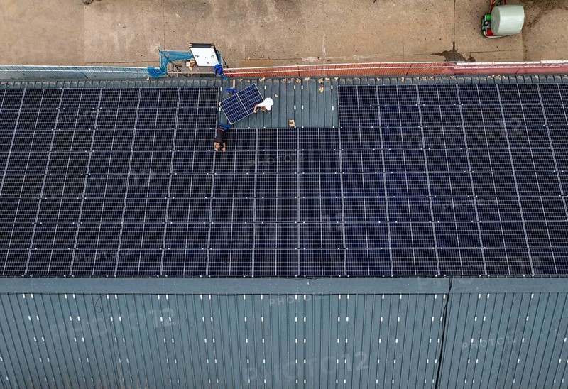 Installation of solar modules on the roof of a barn on a farm, over 210 photovoltaic modules are installed on the roof, North Rhine-Westphalia, Germany, Europe