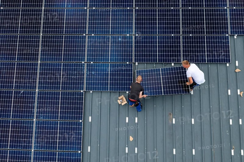 Installation of solar modules on the roof of a barn on a farm, over 210 photovoltaic modules are installed on the roof, North Rhine-Westphalia, Germany, Europe
