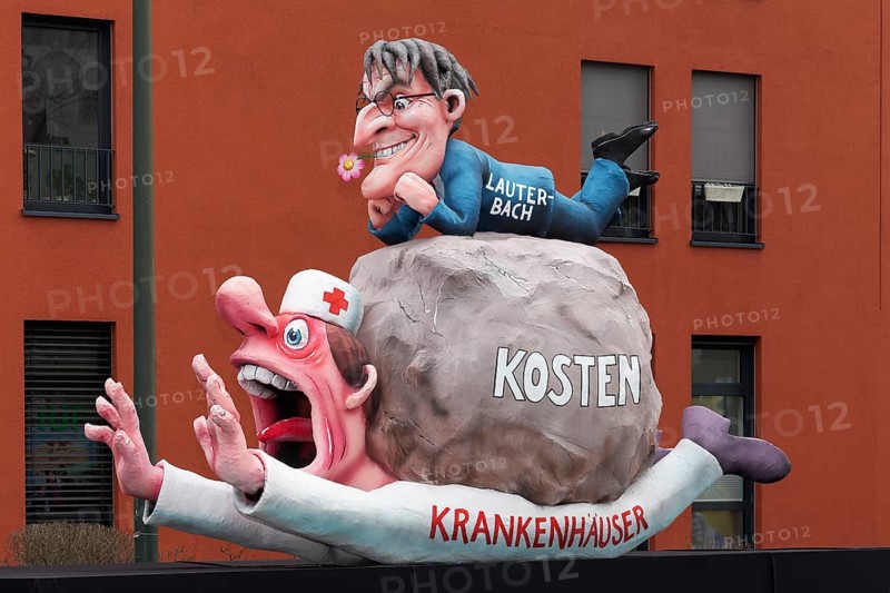 Health Minister Karl Lauterbach puts cost pressure on sick houses, papier-mâché figures, satirical float by Jacques Tilly, Rose Monday parade Düsseldorf, North Rhine-Westphalia, Germany, Europe