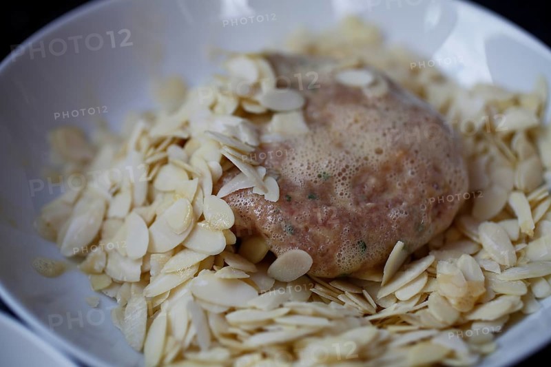 Swabian cuisine, preparation of meatballs in almond coating, mixed minced meat, raw, meatball with egg in almond slices, meatballs, grandmother's cooking, regional, home cooking, typical Swabian, traditional cuisine reinterpreted, food photography, studio, Germany, Europe