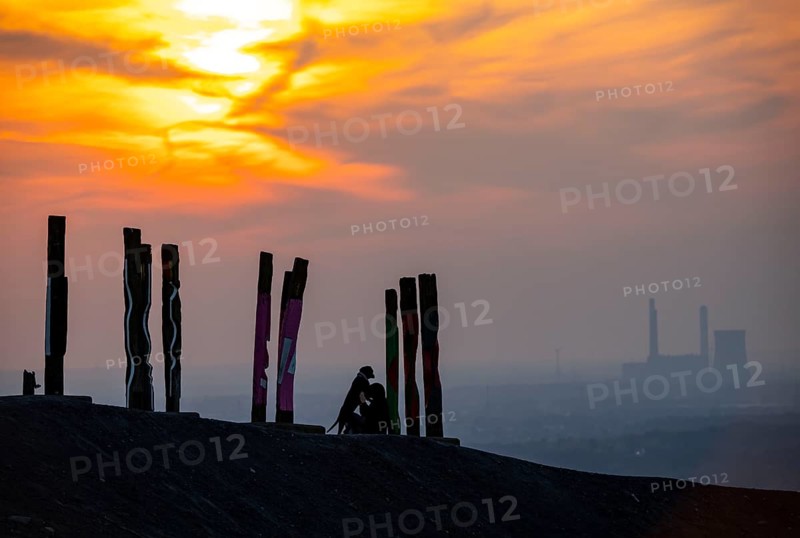 The Haniel spoil tip, 185 metre high spoil tip, at the Prosper Haniel mine, which was closed in 2019, artwork Totems by the sculptor Augustin Ibarrola, sunset, Bottrop, Germany, Europe