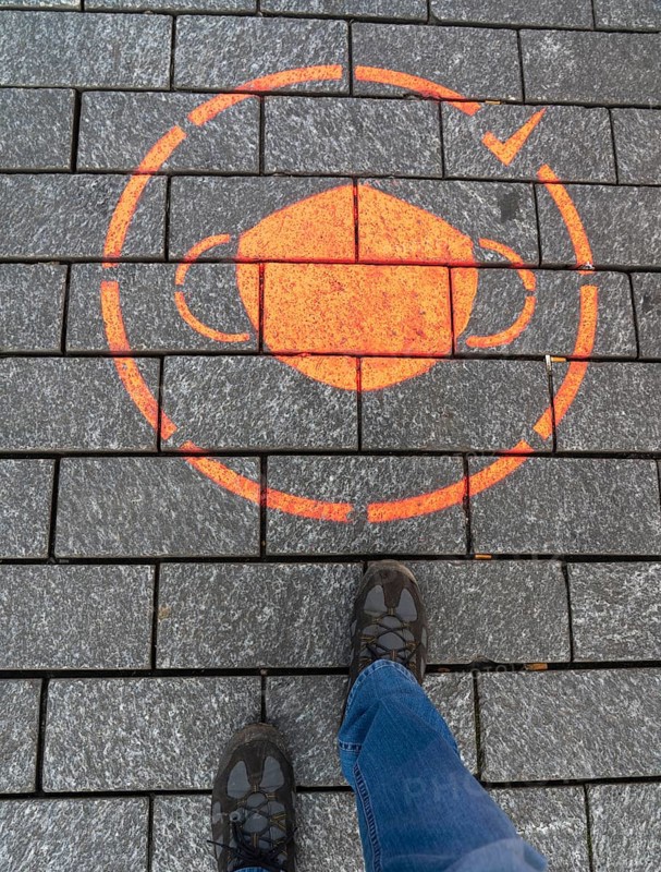 First day of the Christmas lockdown in the Corona crisis, empty shopping street, closed shops, hardly any passers-by, logo on the floor, reference to the obligation to wear masks, in Cologne, North Rhine-Westphalia, Germany, Europe