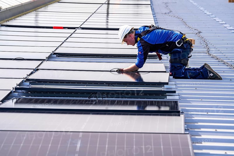 Installation of solar modules on the roof of a commercial enterprise, over 400 photovoltaic modules are installed on the roof, North Rhine-Westphalia, Germany, Europe