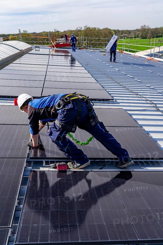 Installation of solar modules on the roof of a commercial enterprise, over 400 photovoltaic modules are installed on the roof, North Rhine-Westphalia, Germany, Europe