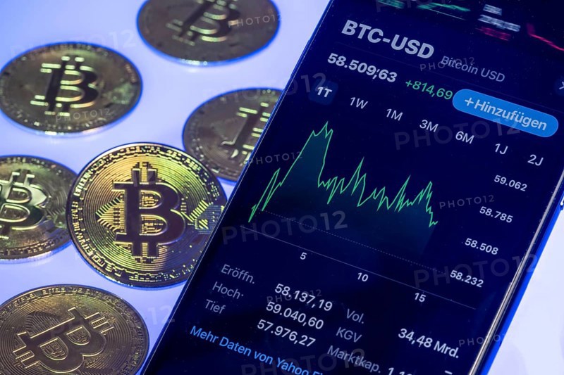Bitcoin cryptocurrency, symbol coin, mobile phone, mobile phone with Bitcoin exchange rates, to the euro, optical placeholder for the digital currency, blockchain, stock exchange rates