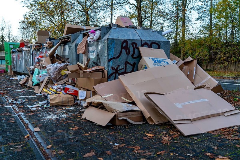 Overfilled waste paper containers, despite the overcrowding, people have put their waste paper next to them, Essen, North Rhine-Westphalia, Germany, Europe