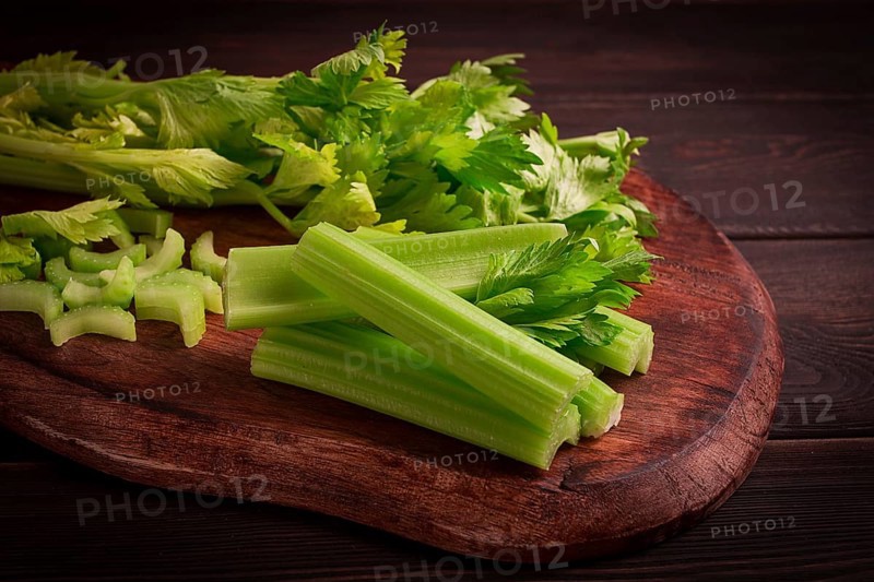 Fresh bunch of celery, top view, no people, on a dark background