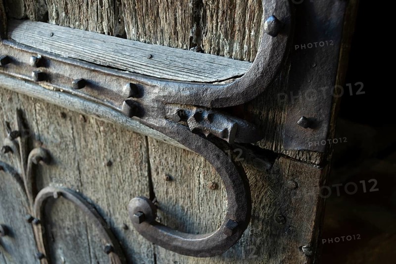 Orcival. Intricate Roman wrought iron hinge displayed at the Basilica Notre-Dame d'Orcival, Puy de dome, Auvergne-Rhone-Alpes, France, Europe