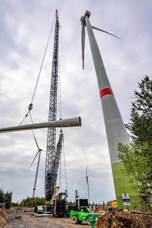 Erection of a wind turbine, wind energy plant, assembly of the third blade, with a crawler lattice crane, wind farm near Hagen, North Rhine-Westphalia, Germany, Europe
