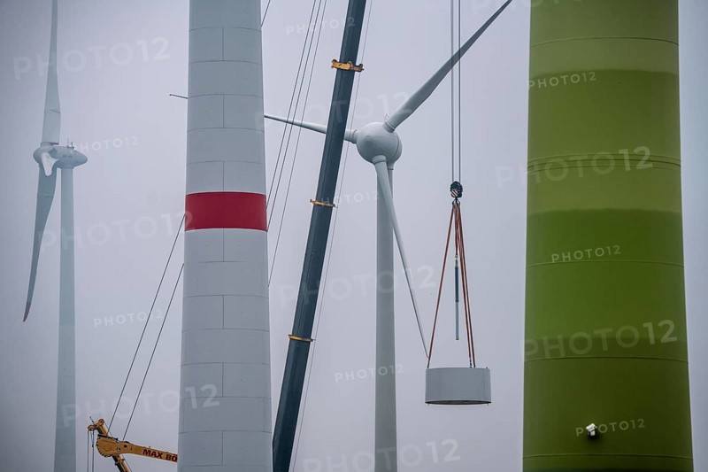 Construction of the tower of a wind power plant in a wind farm near Issum, 9 older wind turbines from the manufacturer Enercon (model series E-58) at the rear right, which have been in operation for over two decades, will be replaced by a total of four Enercon E-160 turbines, under construction, with a total output of 22 megawatts, Lower Rhine, North Rhine-Westphalia, Germany, Europe