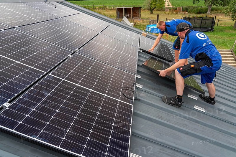 Installation of solar modules on the roof of a barn on a farm, over 240 photovoltaic modules are installed on the roof, North Rhine-Westphalia, Germany, Europe