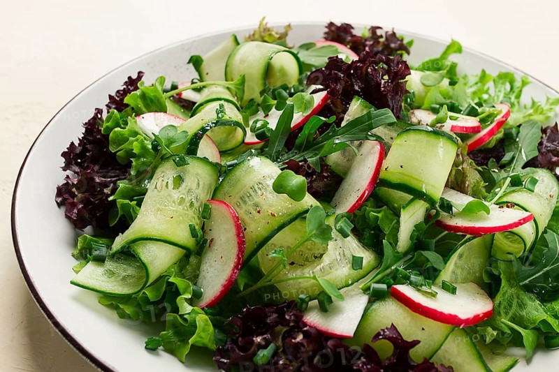 Vegetable salad, radishes and cucumbers, radish micro-greens, lettuce leaves, green onions, homemade, no people