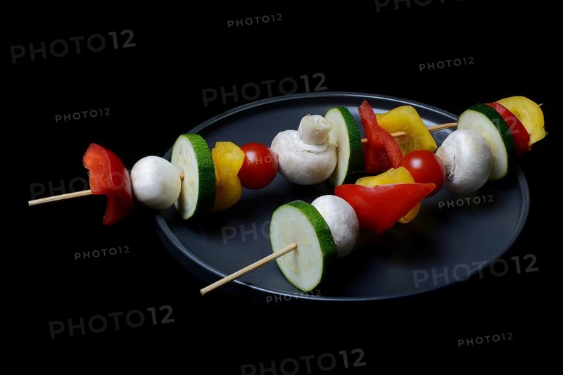Colourful vegetable skewers on a plate, barbecue skewers