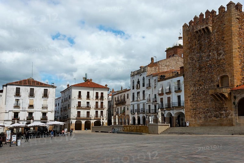 A large square with old buildings, a tower and cafés on the edge, tower, Torre de Bujaco on the right, Plaza Mayor, Cáceres, Caceres, Extremadura, Spain, Europe
