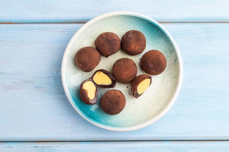 Japanese rice sweet buns chocolate mochi filled with cream on blue wooden background. top view, flat lay, copy space