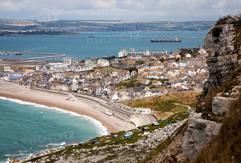Chiswell village at the start of Chesil Beach with Weymouth harbour beyond, Isle of Portland, Dorset, England, United Kingdom, Europe