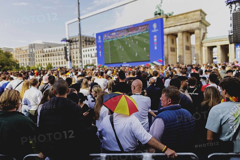 Fans react during the European Championship preliminary round match between Germany and Hungary on the fan mile in front of the Brandenburg Tor in Berlin, 19 June 2024