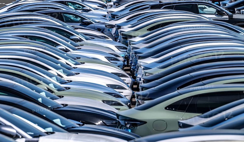 Storage area for new cars in the port of Vlissingen-Oost, vehicles are temporarily stored on over 100 hectares to ship them from Europe to the United Kingdom, Ford cars, others such as models from the Chinese car manufacturer BYD are delivered from here in Europe, wind farm, Netherlands