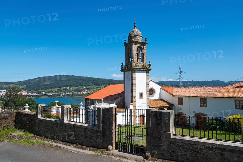 Church with bell tower and closed entrance gate, in the background a hilly landscape and blue sky, Monastery, Mosteiro de San Martiño de Xuvia, Narón, Naron, A Coruña, A Coruna, La Coruña, La Coruna, Galicia, Spain, Europe