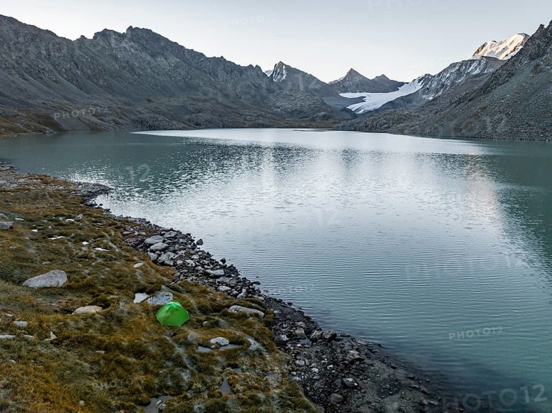 Wild camping, camping with tent in the mountains with glacier, mountain pass and mountain lake Ala-Kul Lake, Tien Shan, Kyrgyzstan, Asia