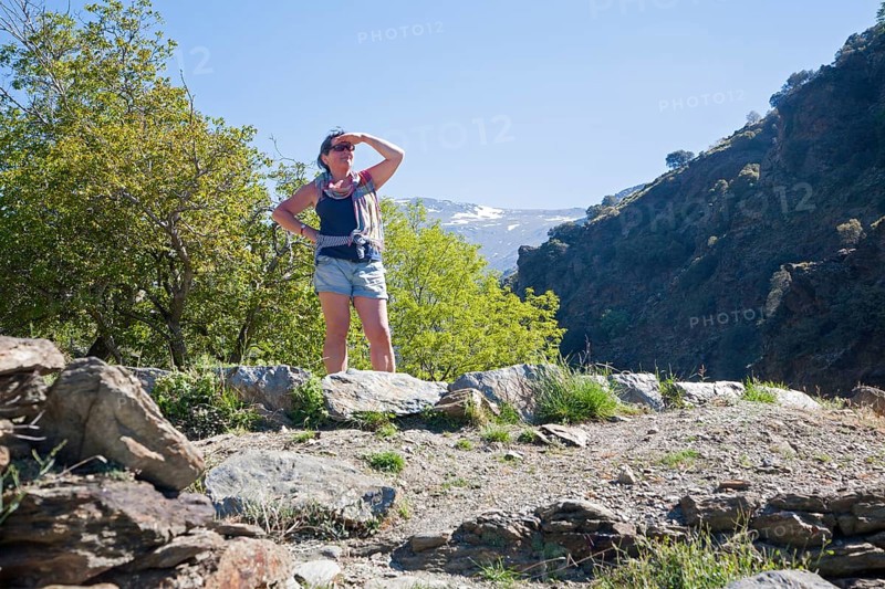 Woman walker and landscape of the River Rio Poqueira gorge valley, High Alpujarras, Sierra Nevada, Granada Province, Spain, Europe