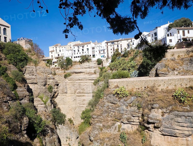 El Tajo canyon of the Rio Guadalevin river with white buildings perched on the cliff top, Ronda, Spain, Europe