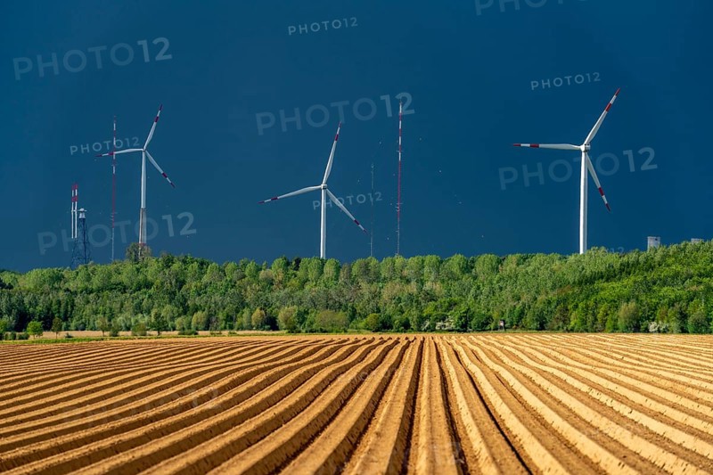Wind turbines on the Grevenbroich wind test field, dark rain clouds, in the Rhenish lignite mining area, field with potato ridges, near Grevenbroich, North Rhine-Westphalia, Germany, Europe