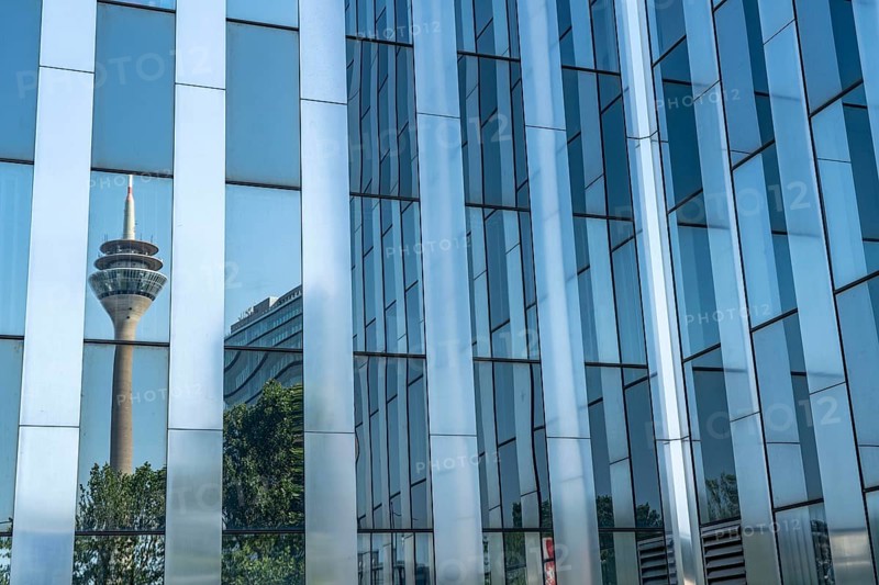 The Rhine Tower reflected in a glazed façade, RWI building, Düsseldorf, North Rhine-Westphalia, Germany, Europe