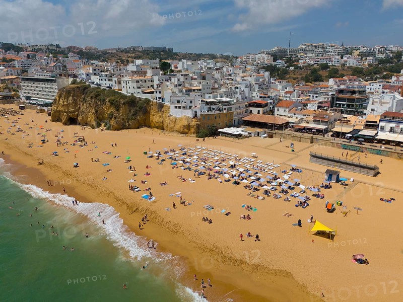 Lively sandy beach with many bathers and urban surroundings in the background, aerial view, Albufeira, Faro, Algarve, Portugal, Europe