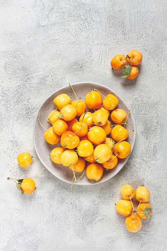 Yellow small apples, Chinese variety, on a gray plate, top view, no people