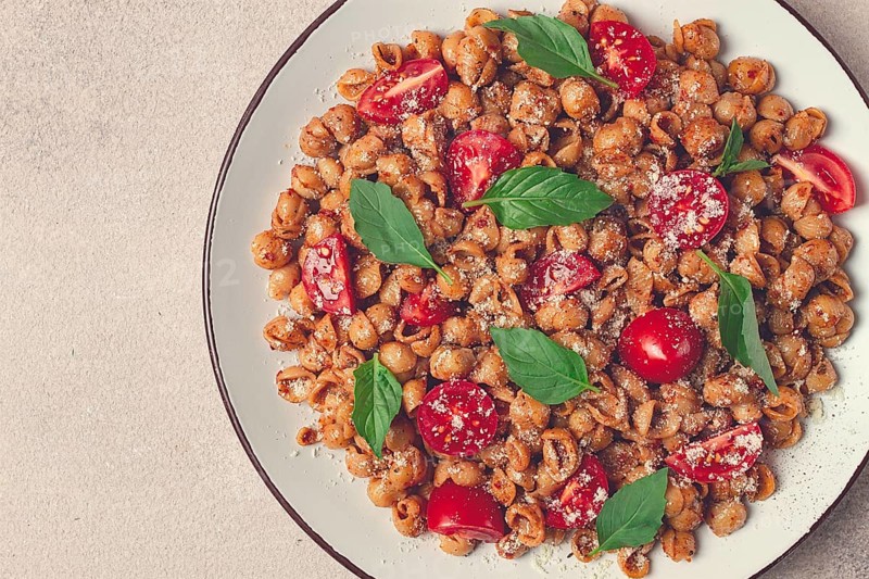 Tuscan pasta with smoked paprika and basil, parmesan cheese, Italian traditional cuisine