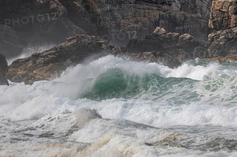 Large waves of the Atlantic Ocean crash against the rocks of a cliff. Camaret sur mer, Crozon, Finistere, Brittany, France, Europe