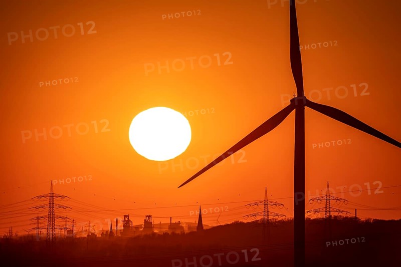 Wind turbine of the Emschergenossenschaft, view to the west, in Essen, sunset, behind the blast furnaces 8 and 9 of Thyssenkrupp Steel, in Duisburg, North Rhine-Westphalia, Germany, Europe