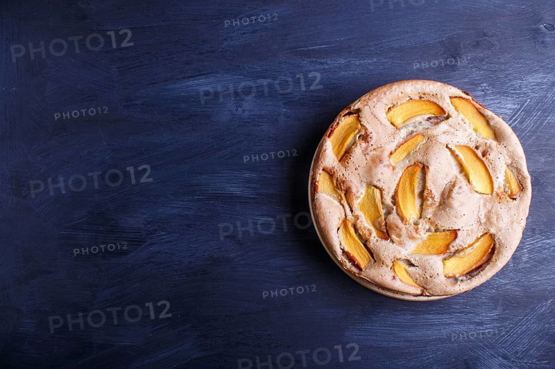 Sweet persimmon pie on black wooden background. top view, copy space