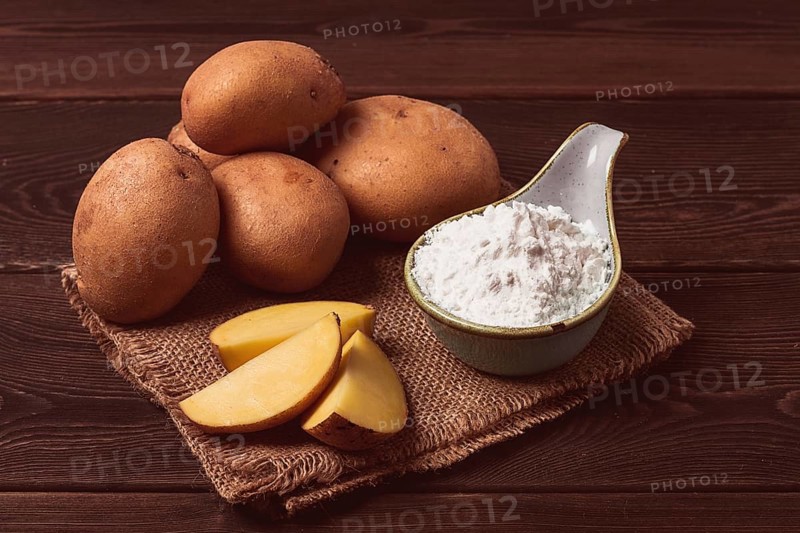 Potato starch, on a wooden table, close-up, rustic style, no people, potatoes, ceramic spoon, saucepan, wooden table, brown