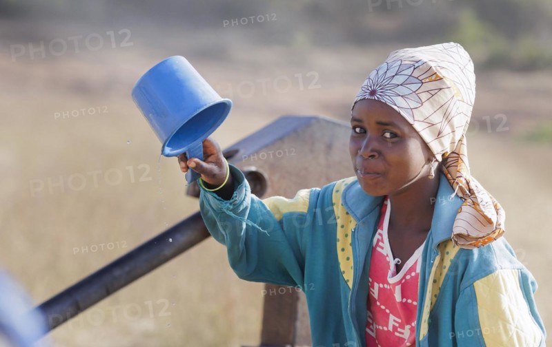 Young woman, girl drinking water from a plastic cup in Maraban Dare community in Plateau state, Nigeria, 07/02/2024, Africa