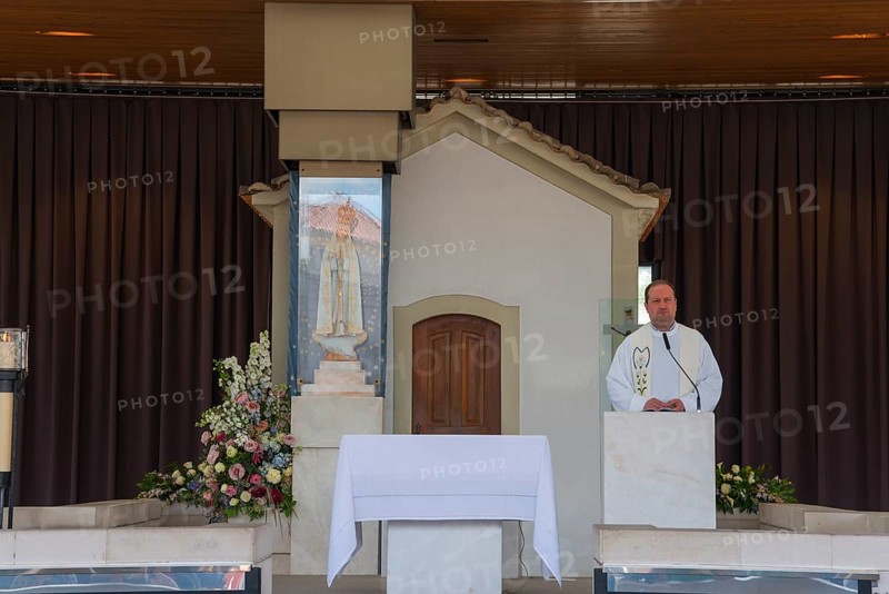 Priest standing at the altar in a small chapel surrounded by flowers, Apparition Chapel, Santuario de Fatima, Place of Pilgrimage, Fatima, Fátima, Ourem, Santarem, Portugal, Europe
